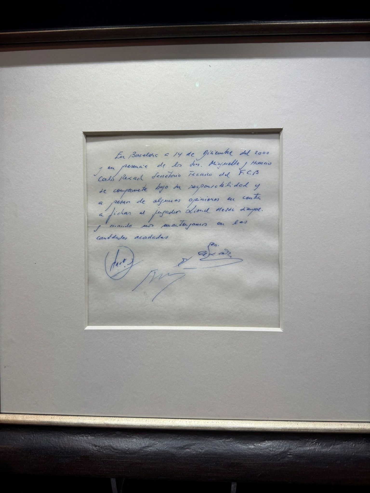 Signed and framed napkin on which Barcelona promised to sign a 13-year-old Lionel Messi