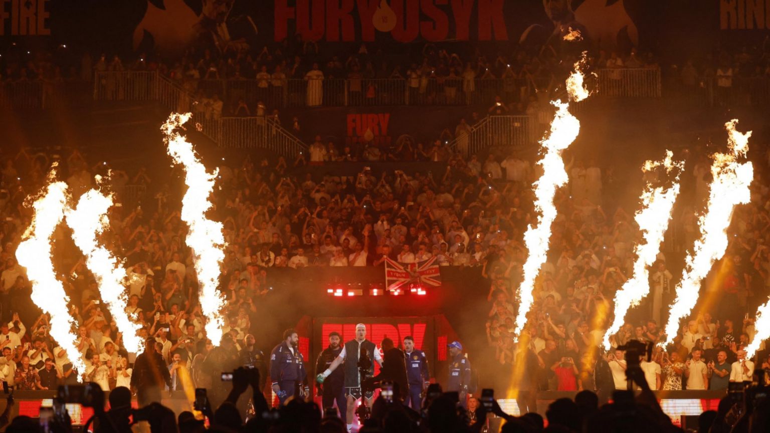 Tyson Fury enters an arena flanked by fire