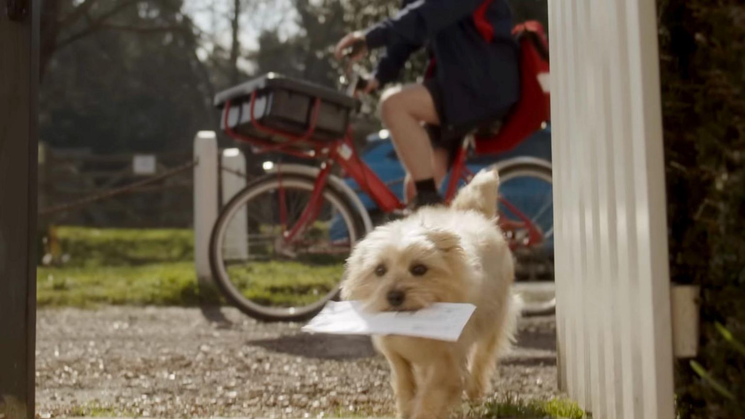 Winnie in the video carrying an envelope