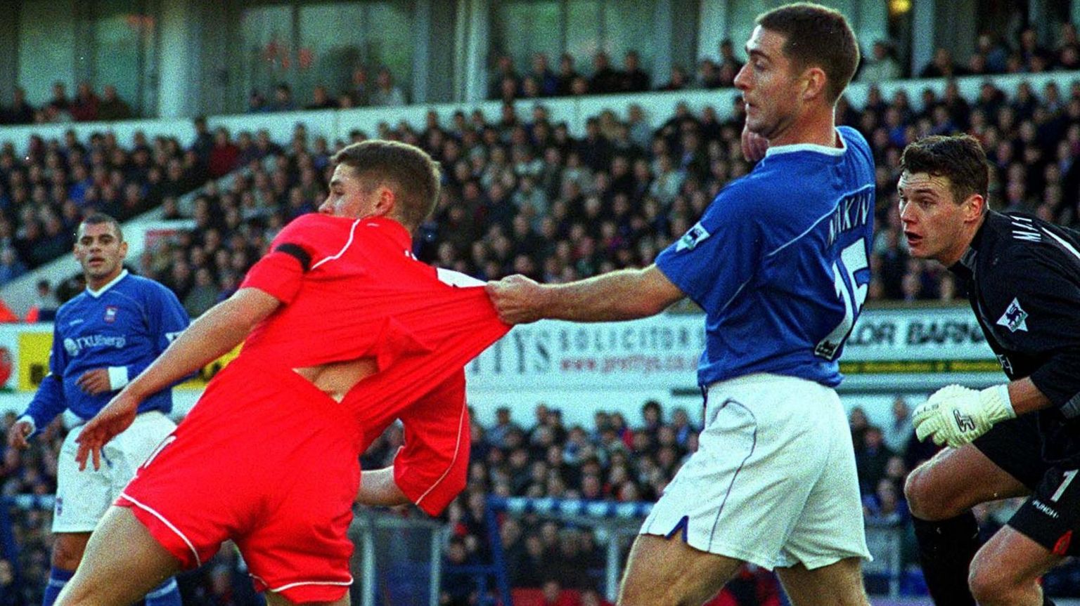 Ipswich's Chris Makin tussles with Michael Owen of Liverpool