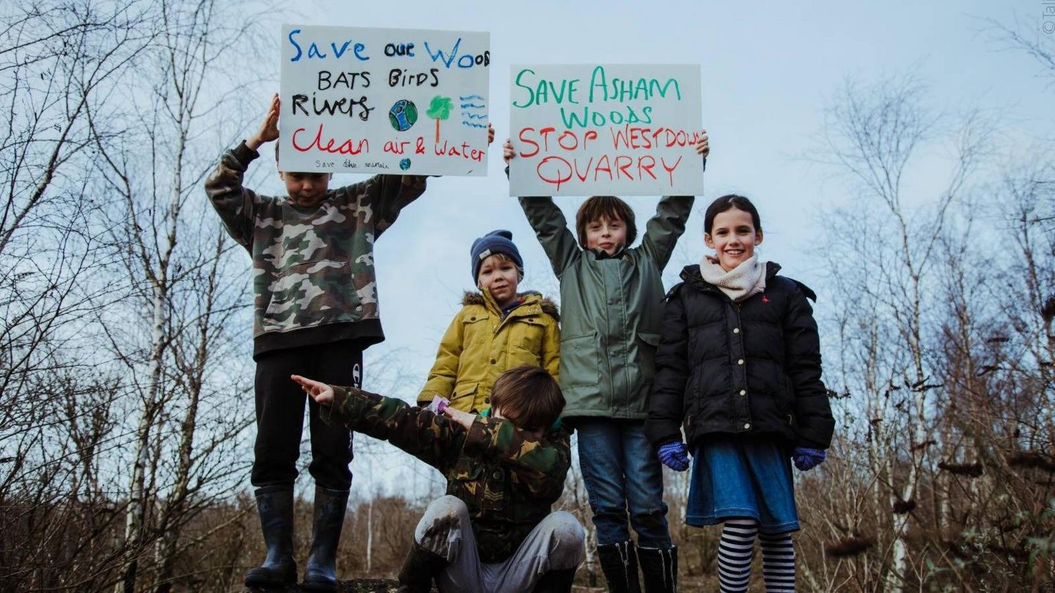 Five children hold protestor signs opposing Westdown Quarry