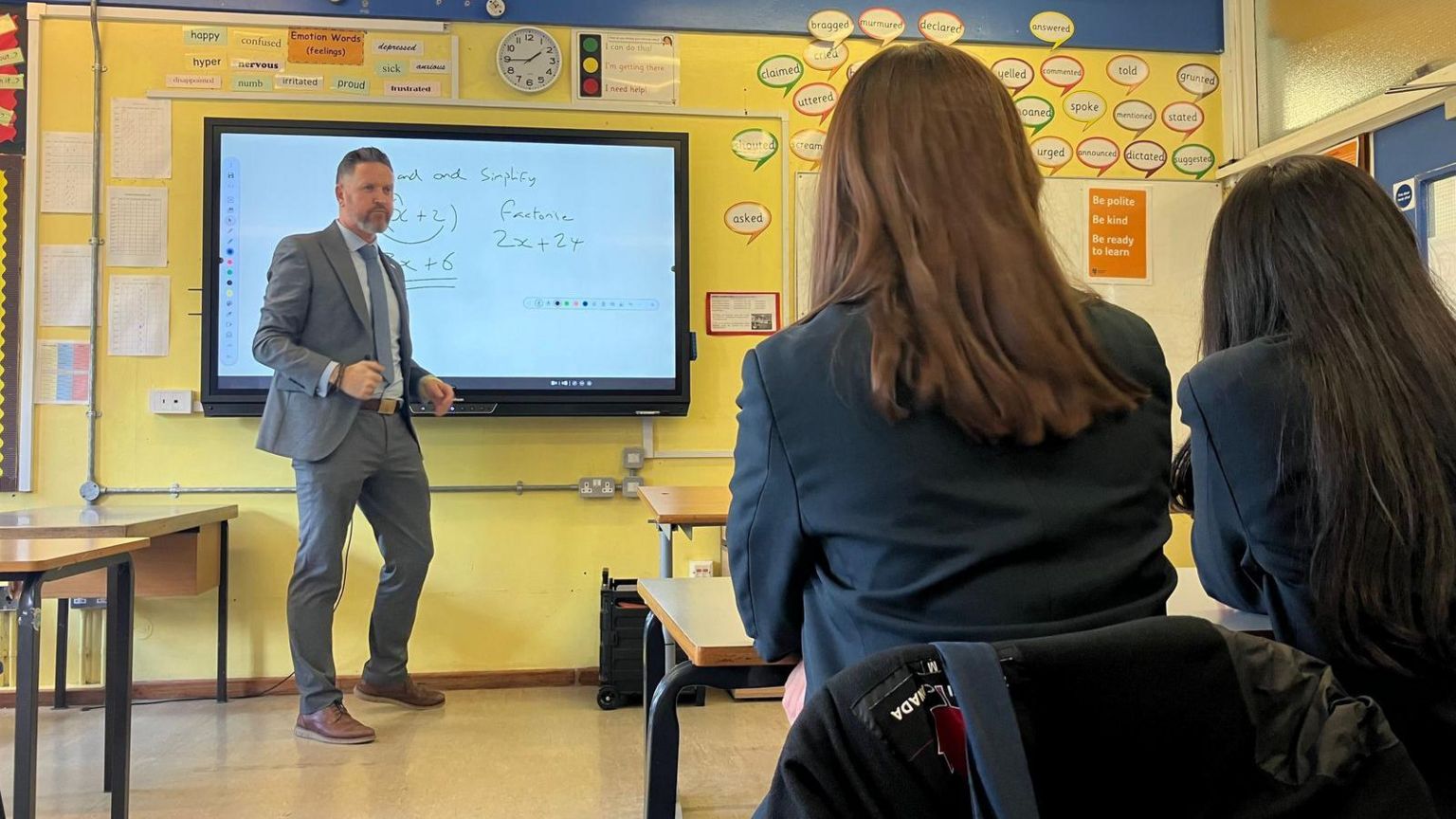 Principal Simon Hart stands at the front of a classroom, teaching maths