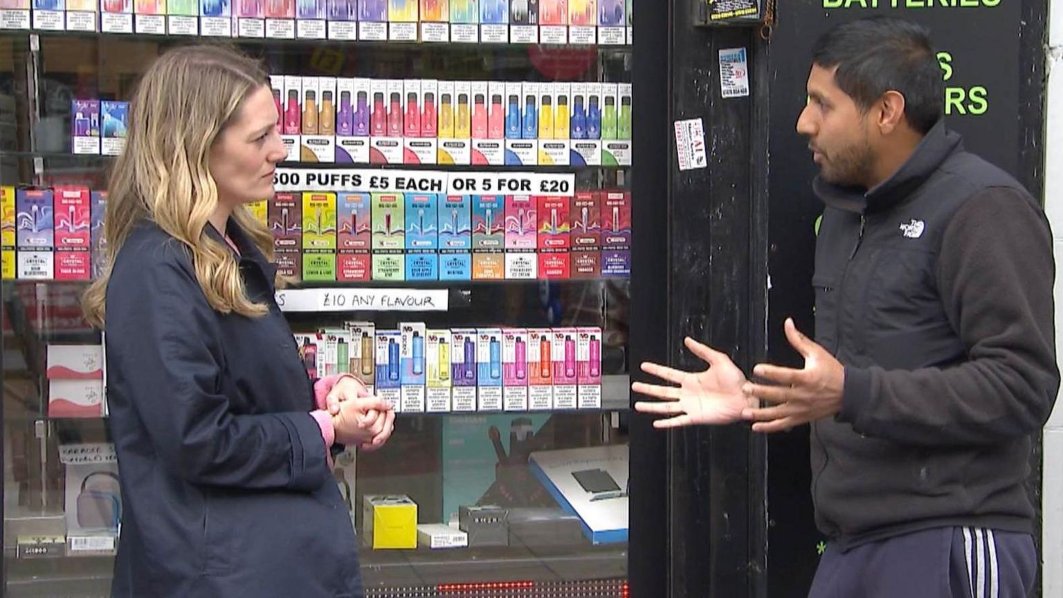 Dalip Singh speaks to Charlotte Wright outside his shop in Medway