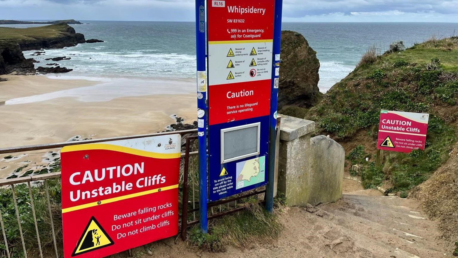 The signs at the top of the steps to Whipsiderry beach