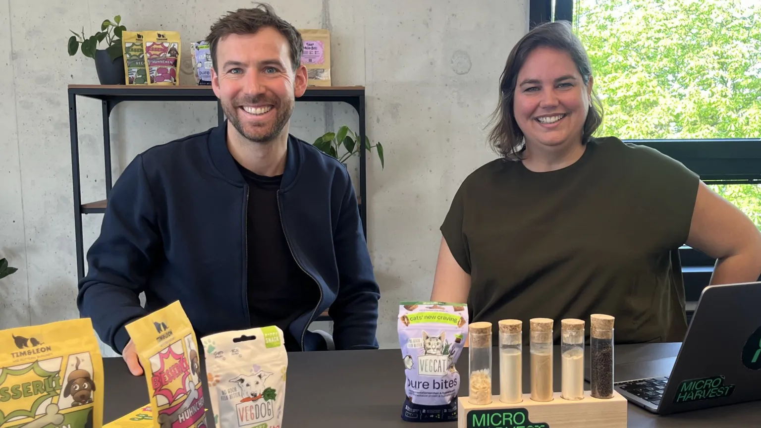 Christine Ro Jonathan Roberz and Katelijne Bekers, MicroHarvest co-founders, sit at a bench with samples of their products in front of them.