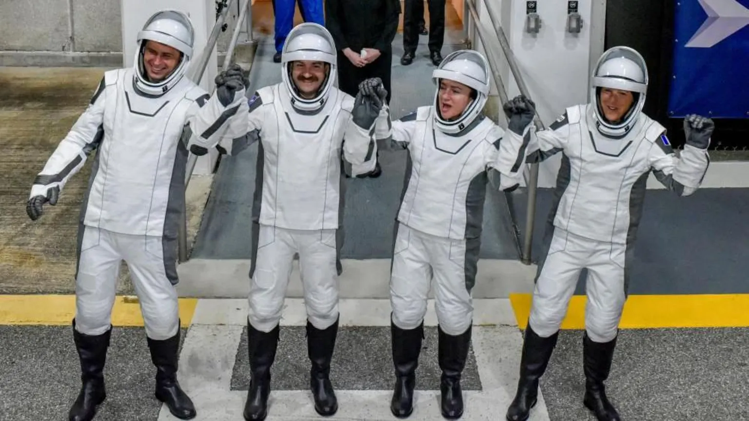 Reuters Four astronauts in white space suits hold hands and lift them in celebration at the Kenedy Space Centre entrance