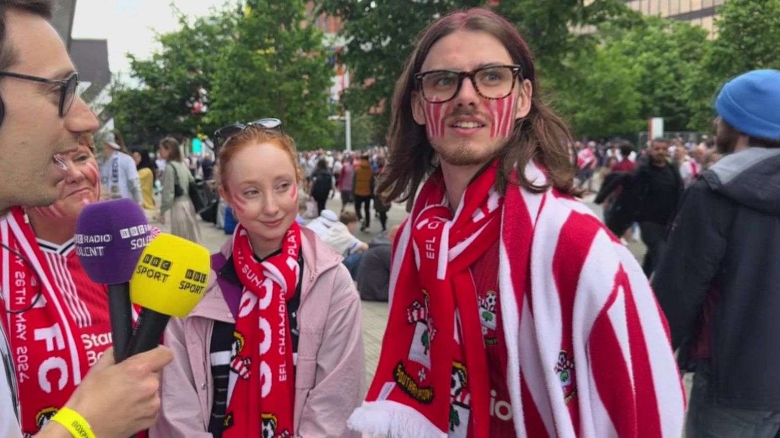 saints fan in red and white striped dressing gown