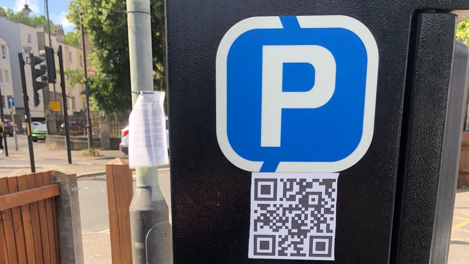 Parking ticket machine with QR code close to road