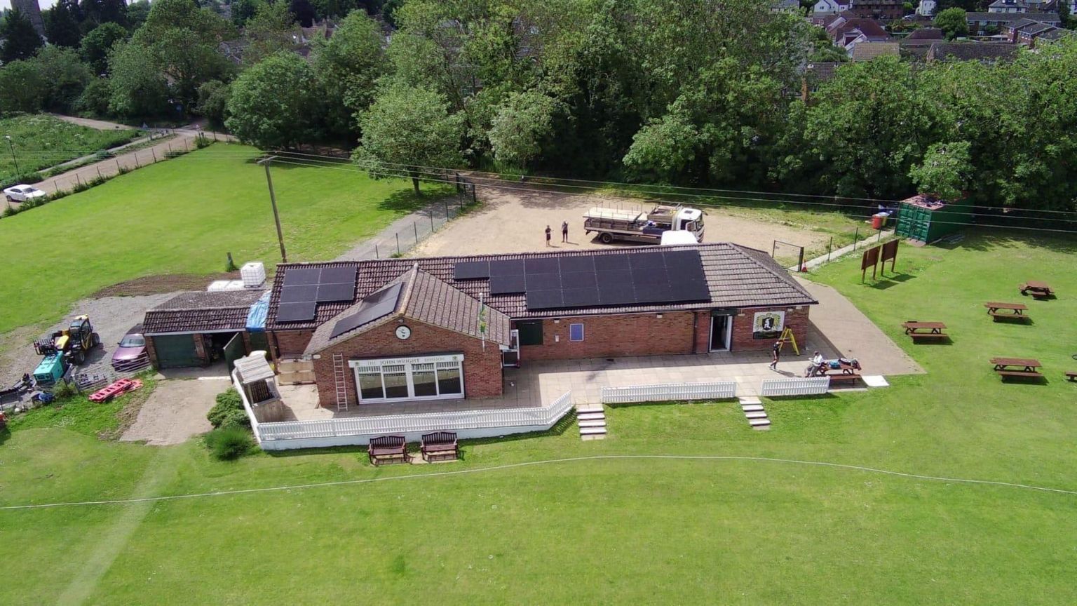 Aerial view of the Eaton Socon Cricket Club pavilion with solar panels on the top of the building