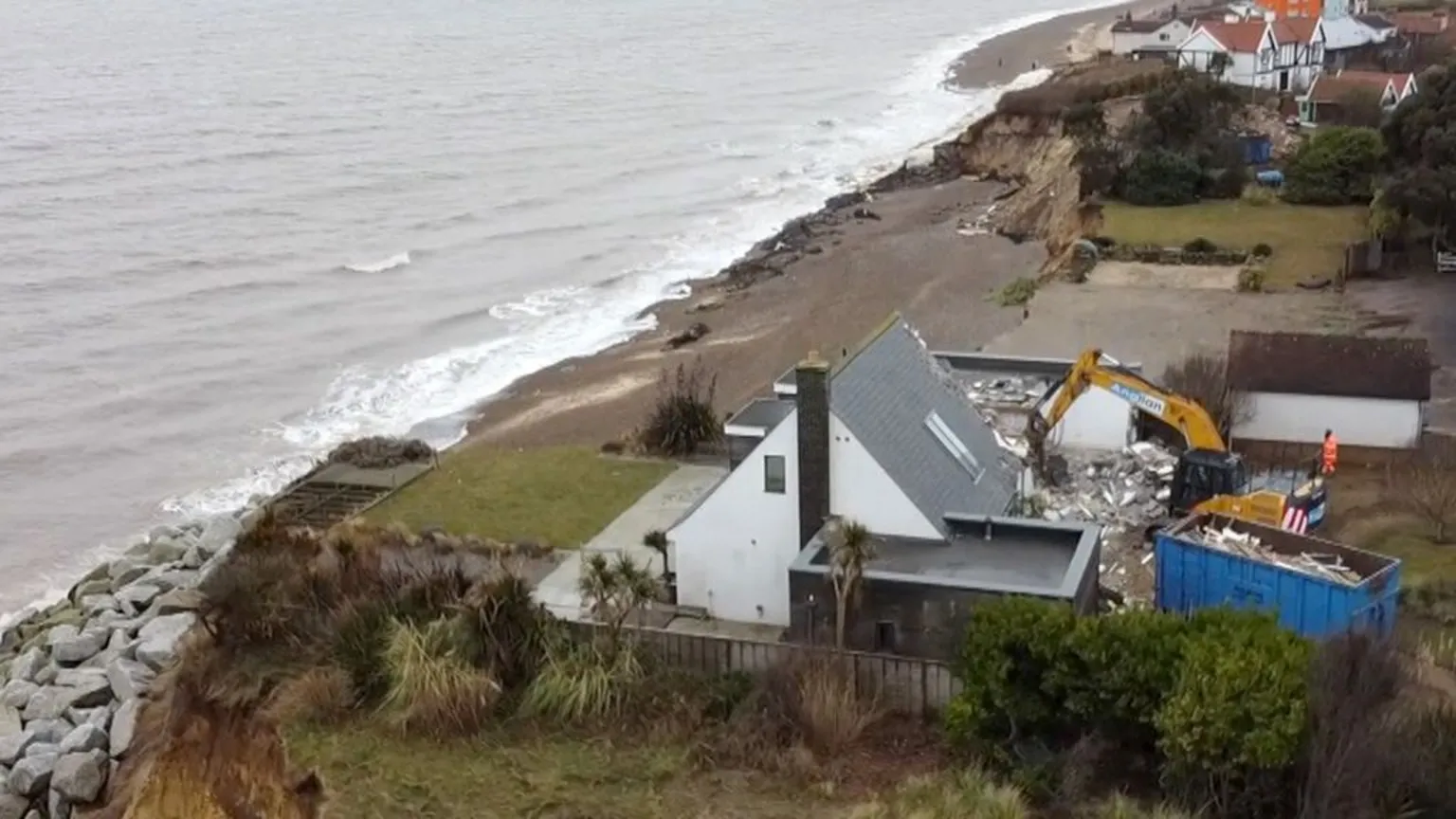 Aerial view of home being demolished on cliff at Thorpeness in Suffolk