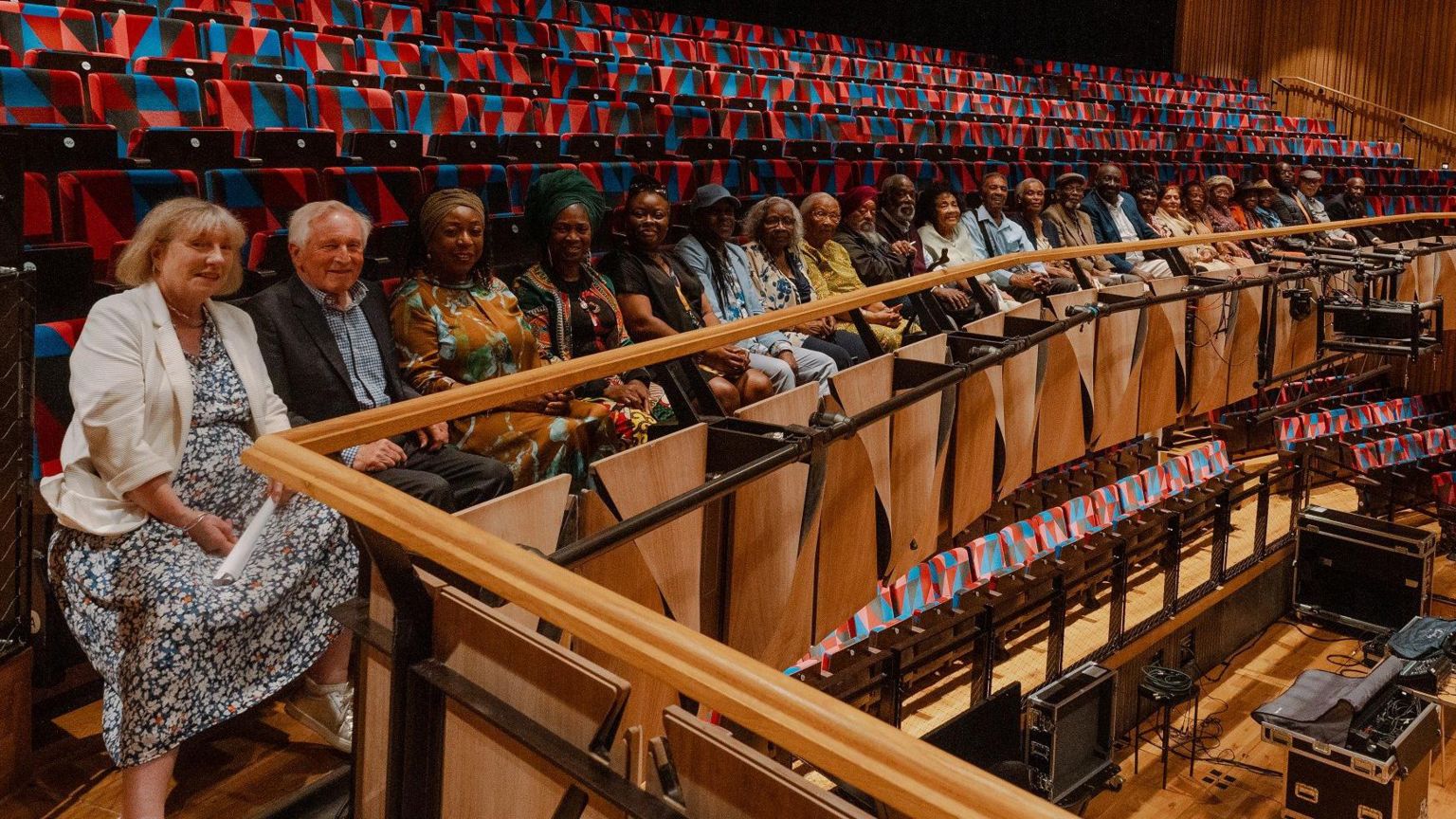 A row of people sit in sits at the Bristol Beacon to honour members of the Windrush generation