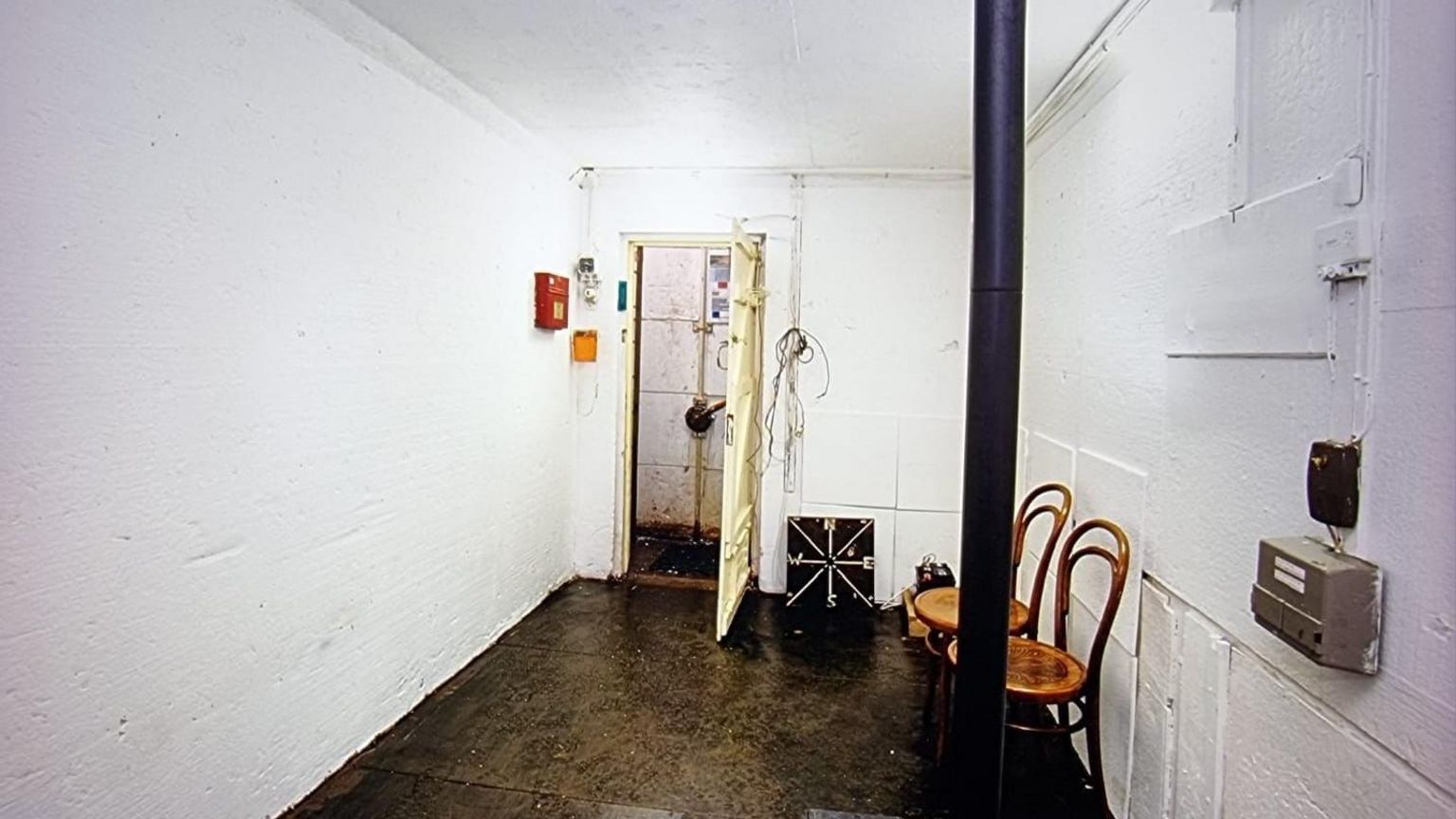 Image of bunker with chairs and white walls