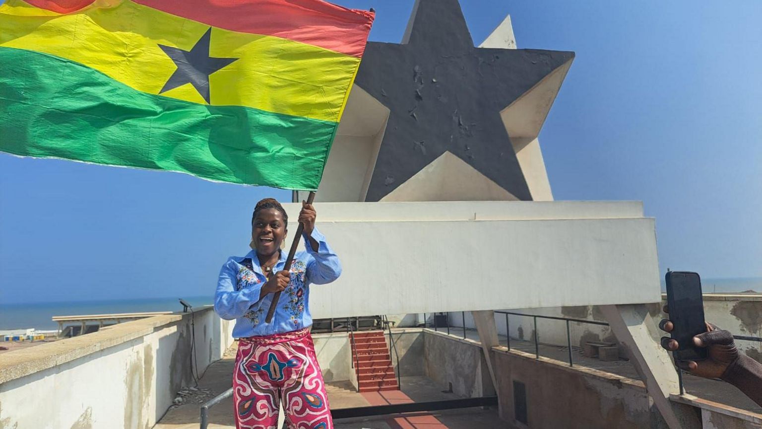 Ms Gyamfi flying Ghana's flag at Independence Square in Osu, Accra