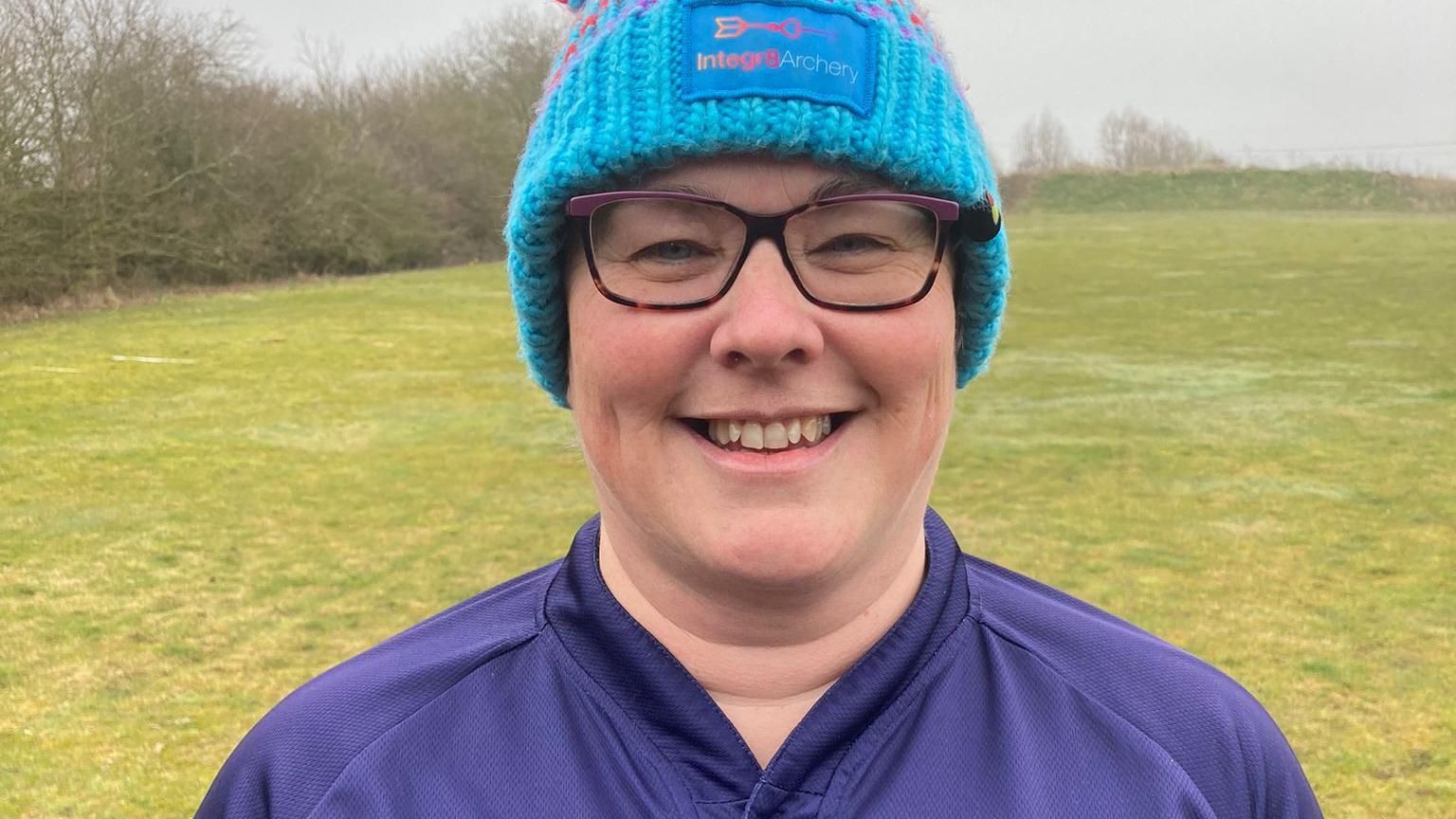 Helen Sharpe, in a blue beanie, smiling at the camera