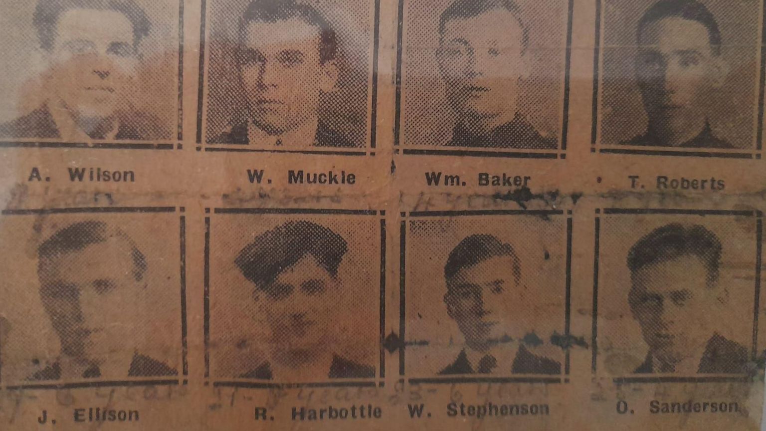 A newspaper cutting showing head shots of the eight miners who were imprisoned following the derailment