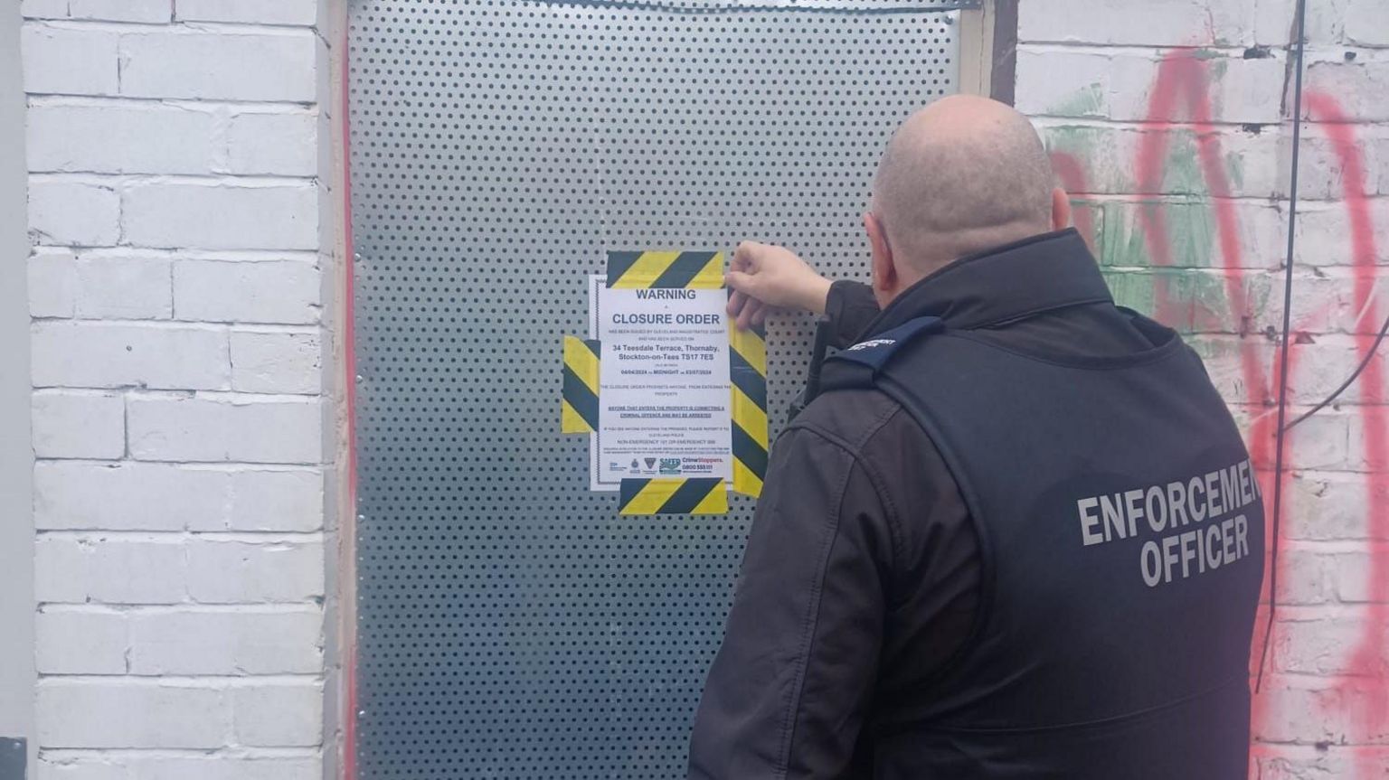 An enforcement officer attaches a closure order on the property in Teesdale Terrace in Thornaby