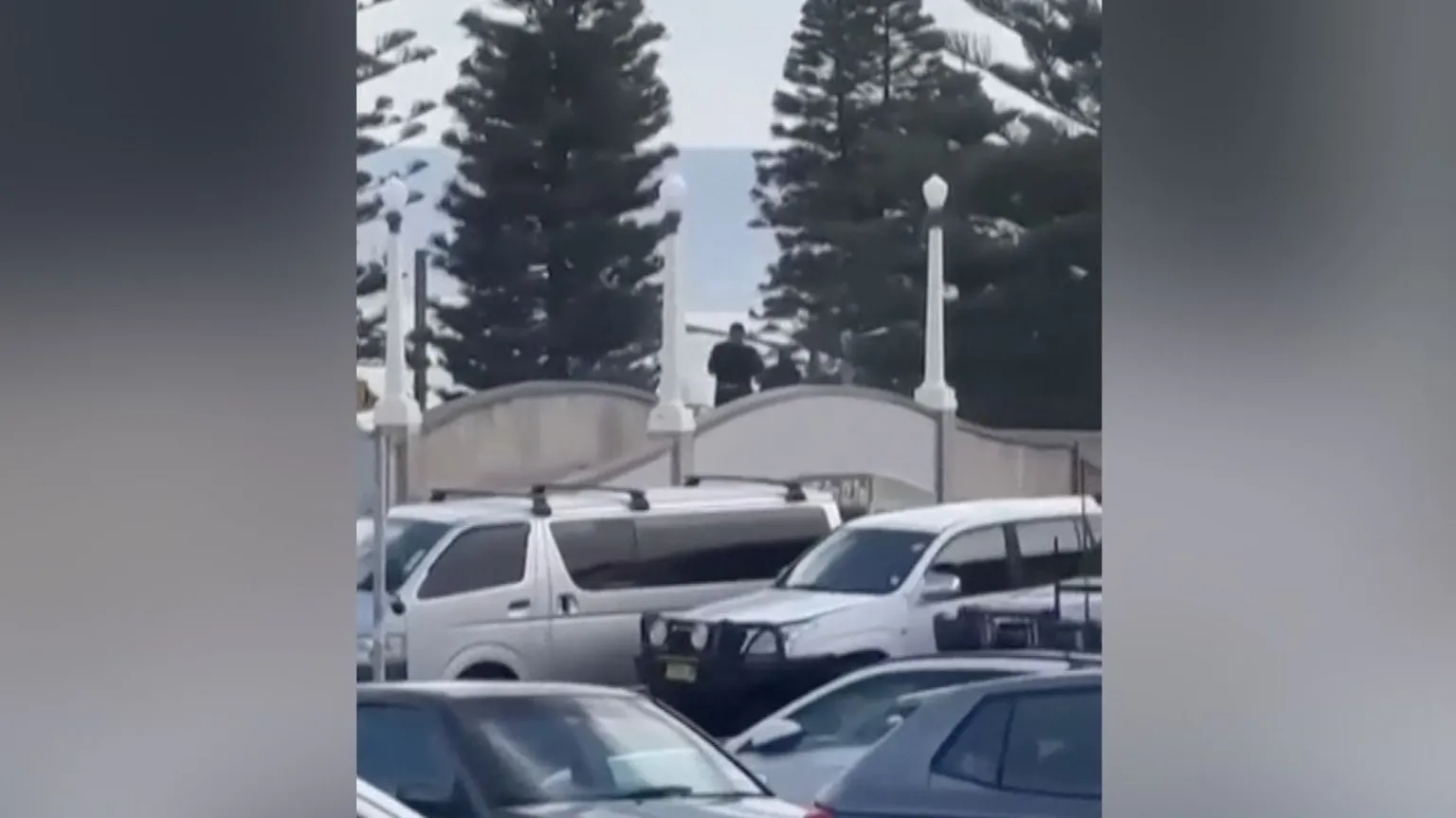 Gunmen dressed in black on a bridge