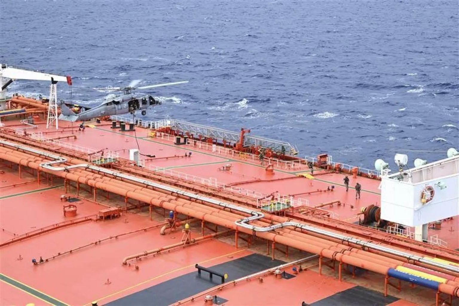US Department of Defense An image showing a helicopter landing on the deck of an oil tanker