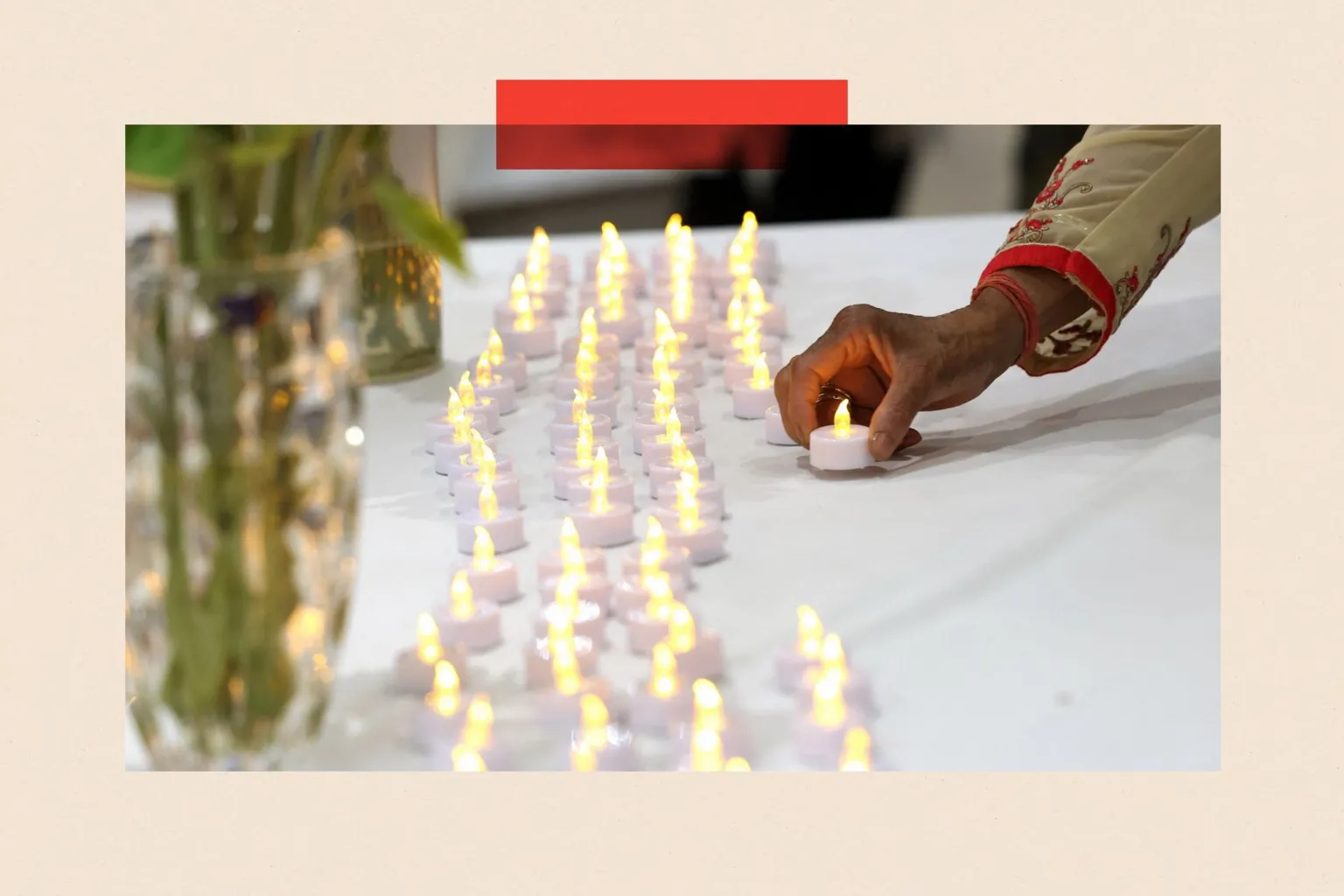 Reuters A woman lays a candle to join rows of others