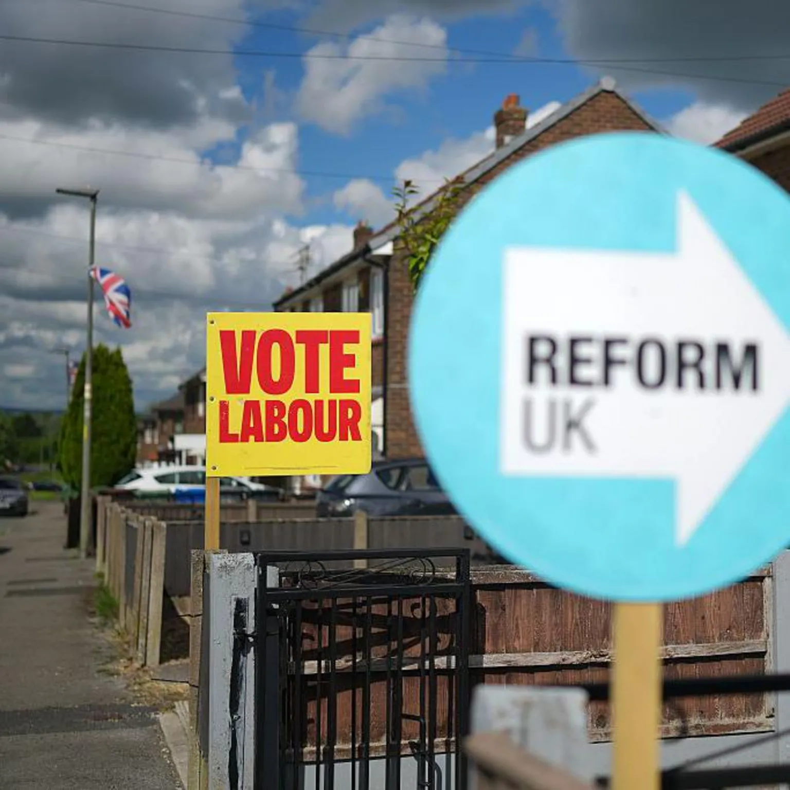 Getty Images Neighbouring homes show their support for Labour and Reform UK with placards ouside their homes on June 10, 2026 in Ashton-in-Makerfield, England