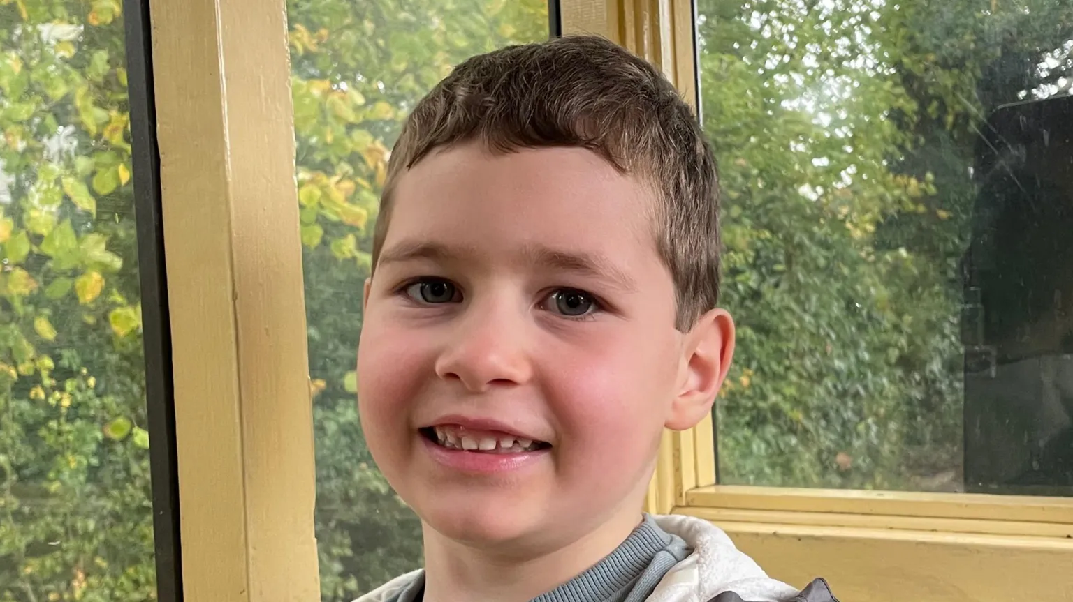 Supplied A close-up head and shoulders image of a young boy. He is smiling and looking into the camera.