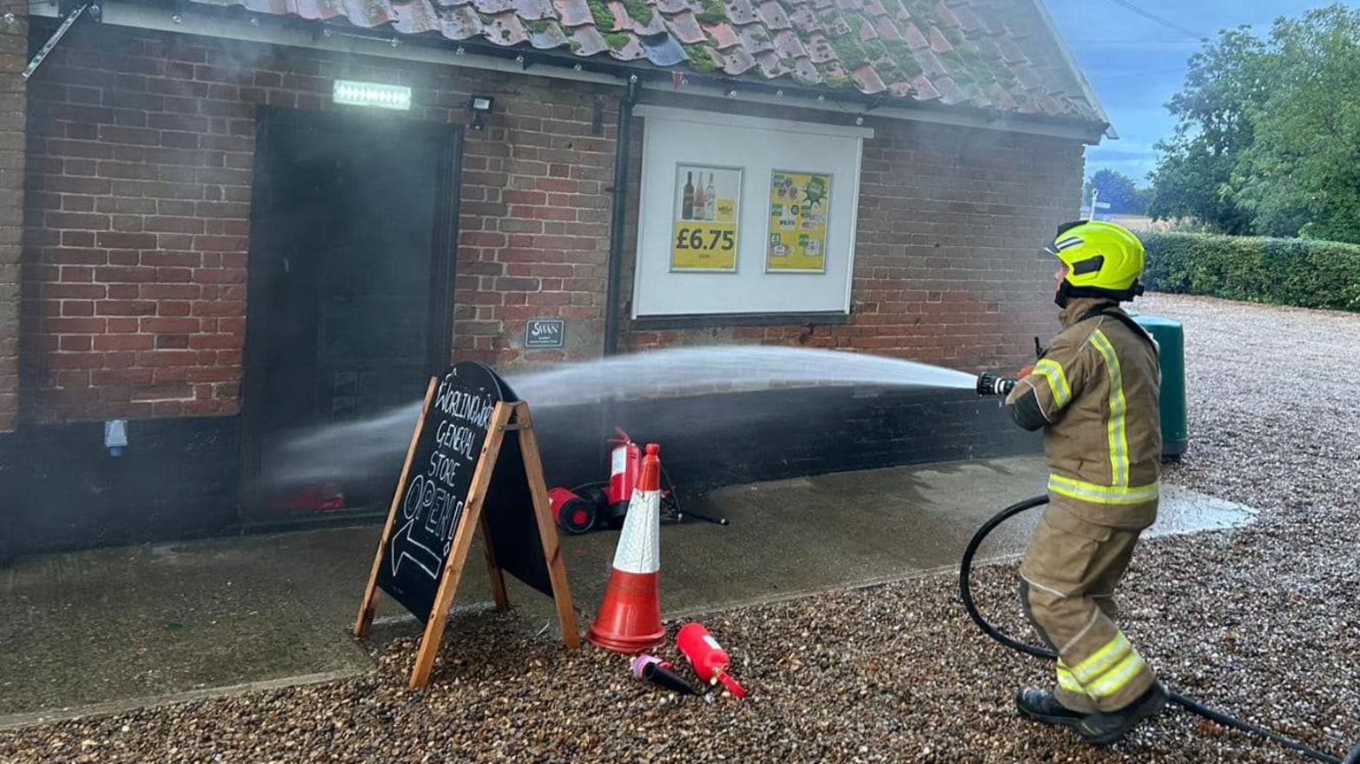 A firefighter tackling a fire at Worlingworth Swan, Suffolk
