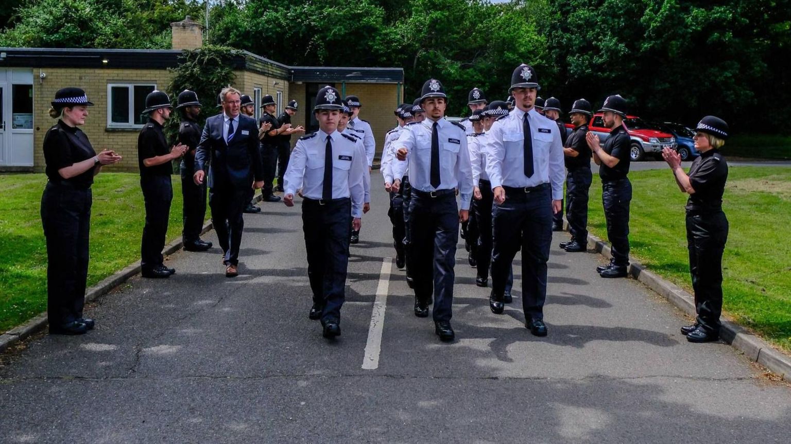 Police recruits being clapped by Cambridgeshire Police officers