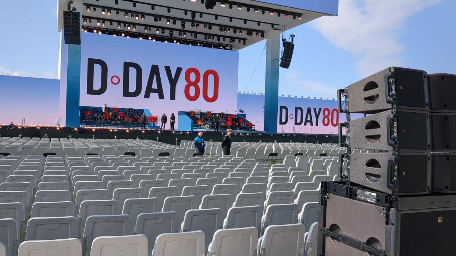 Stage and chairs in Southsea Portsmouth, with a big backdrop saying D-Day 80