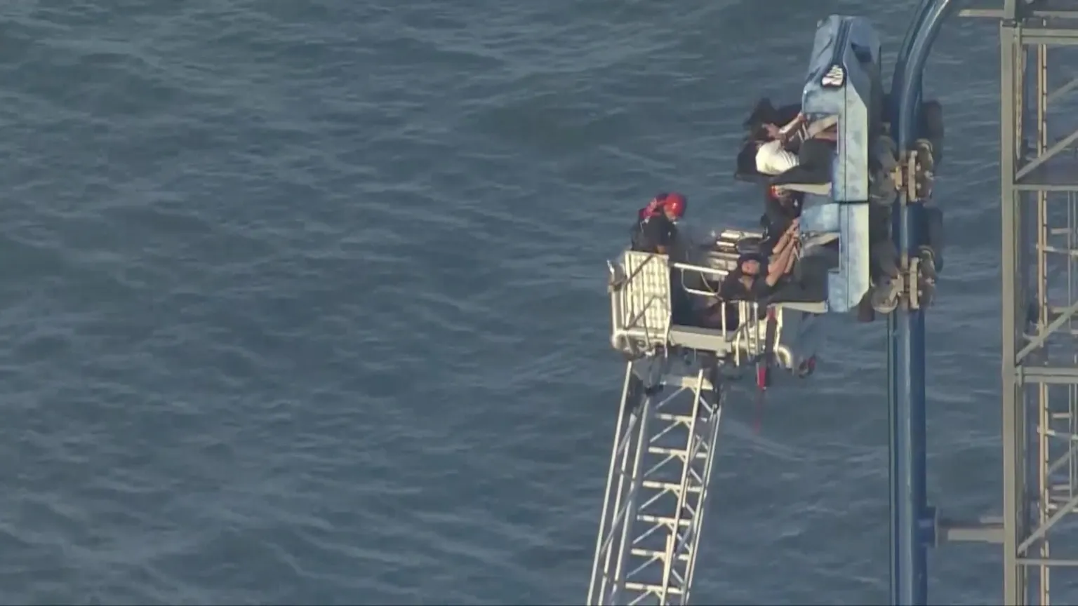 Firefighers rescue the trapped riders.