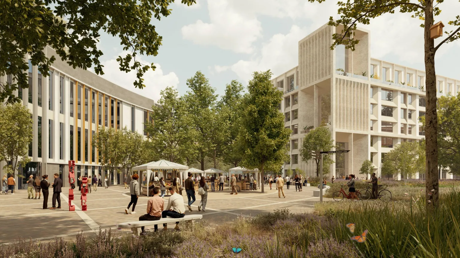 Allies and Morrison/Kin Creatives An artist's impression of part of the future science park. There is a border of wildflowers and trees in the foreground, alongside a paved square with gazebos erected for pop up stalls and people milling around and sitting on benches. in the background, two large buildings featuring large glass windows, stand three storey high.