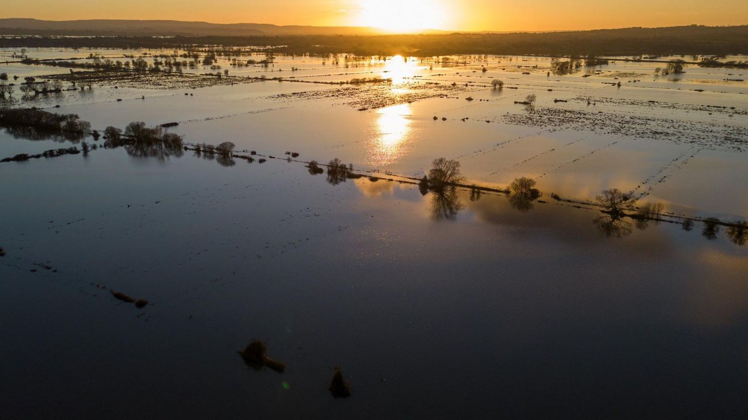 Flooding on the Somerset Levels at sunset, seen from the air