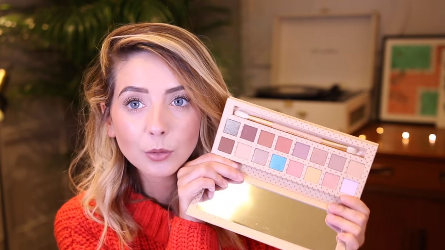 Screenshot of beauty vlogger Zoella holding an eyeshadow palette