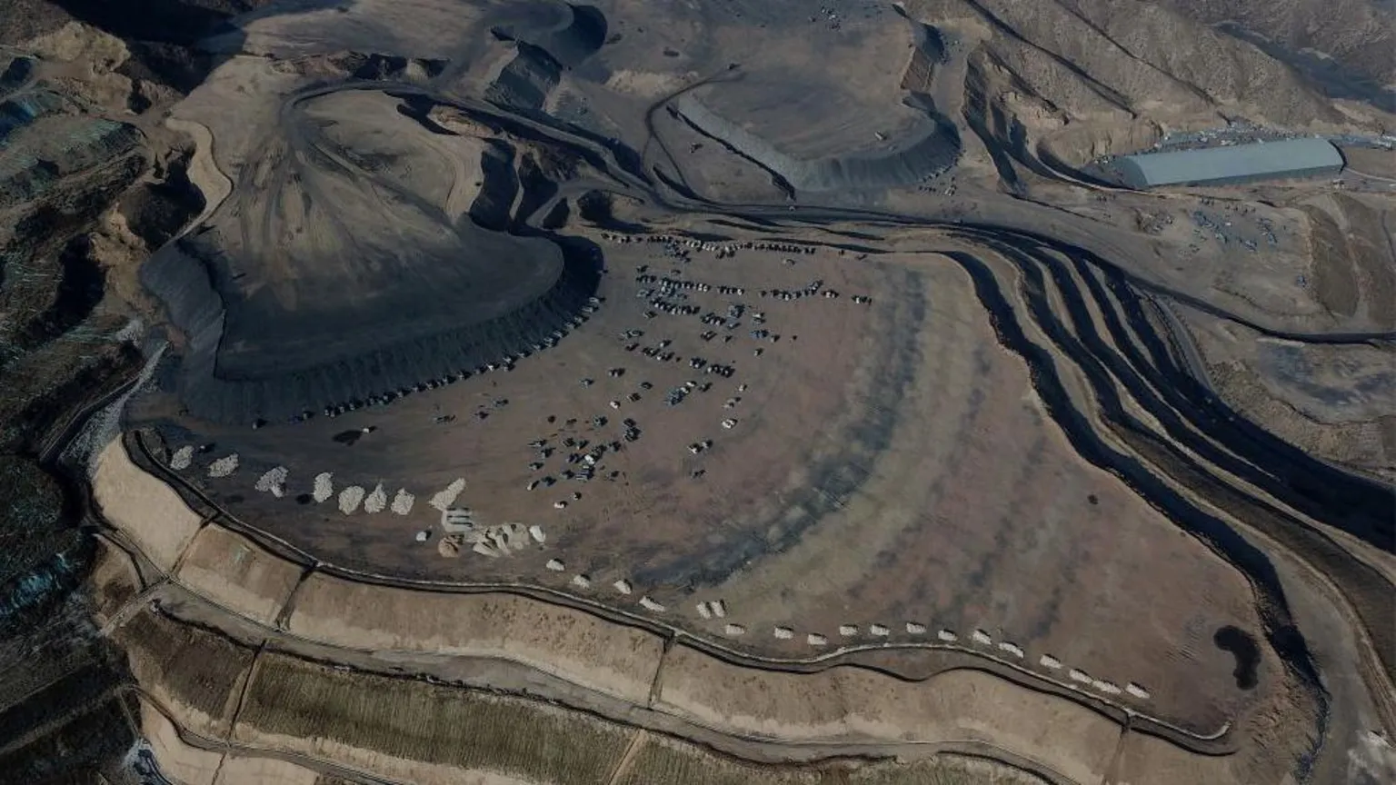 Getty Images Aerial view shows coal being loaded onto trucks near a coal mine in Datong, China's northern Shanxi province on November 2, 2021.
