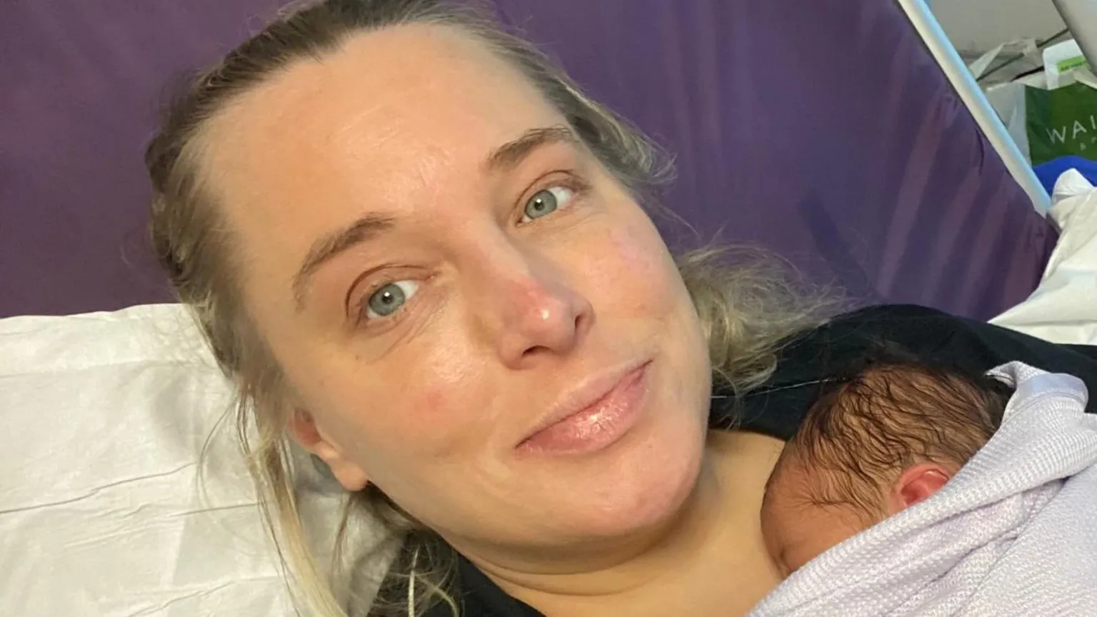 Vicki Rose Vicki Rose - a blonde woman with green eyes - holds her newborn baby against her chest