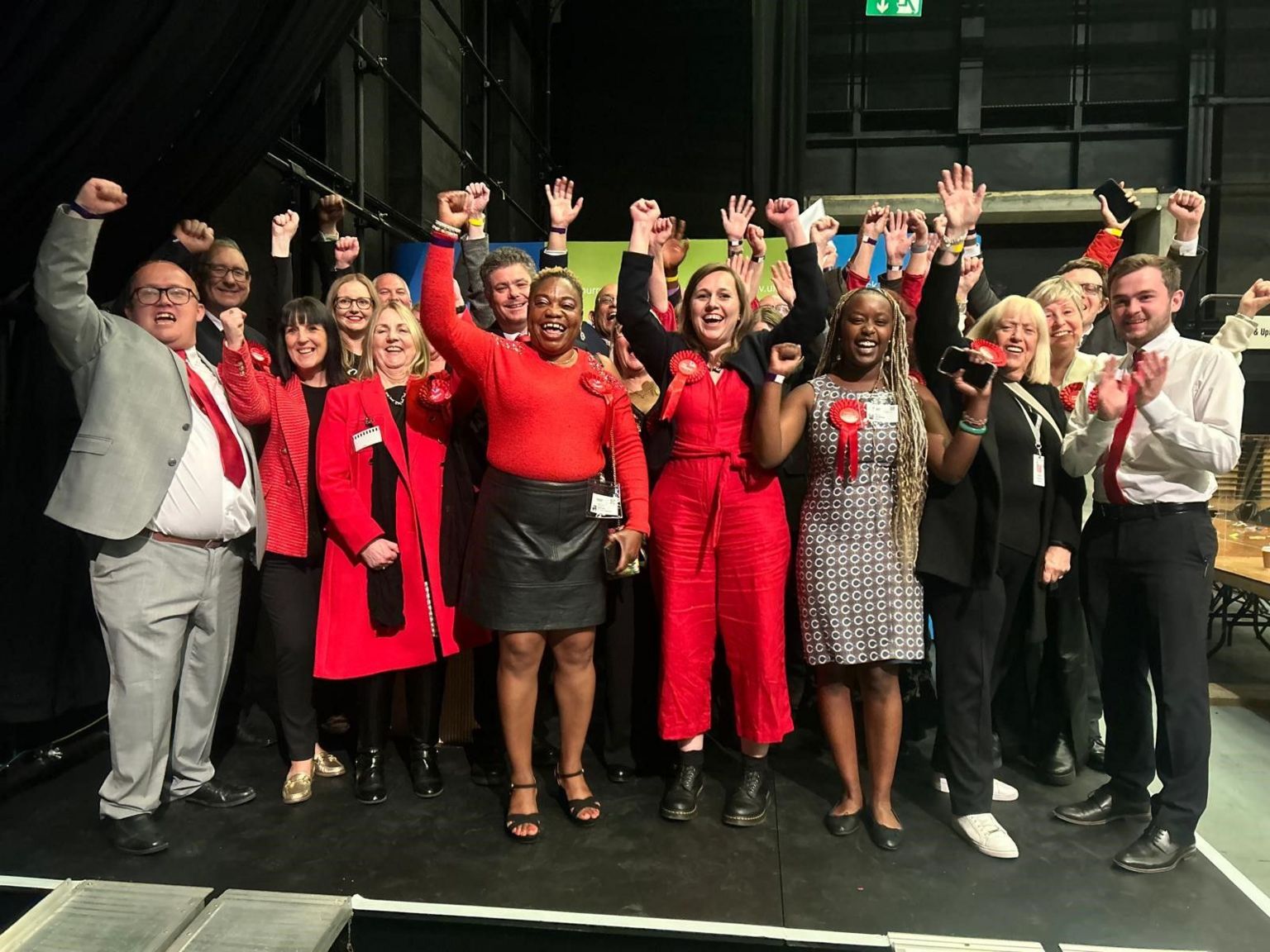 A group of Labour councillors celebrating on a stage