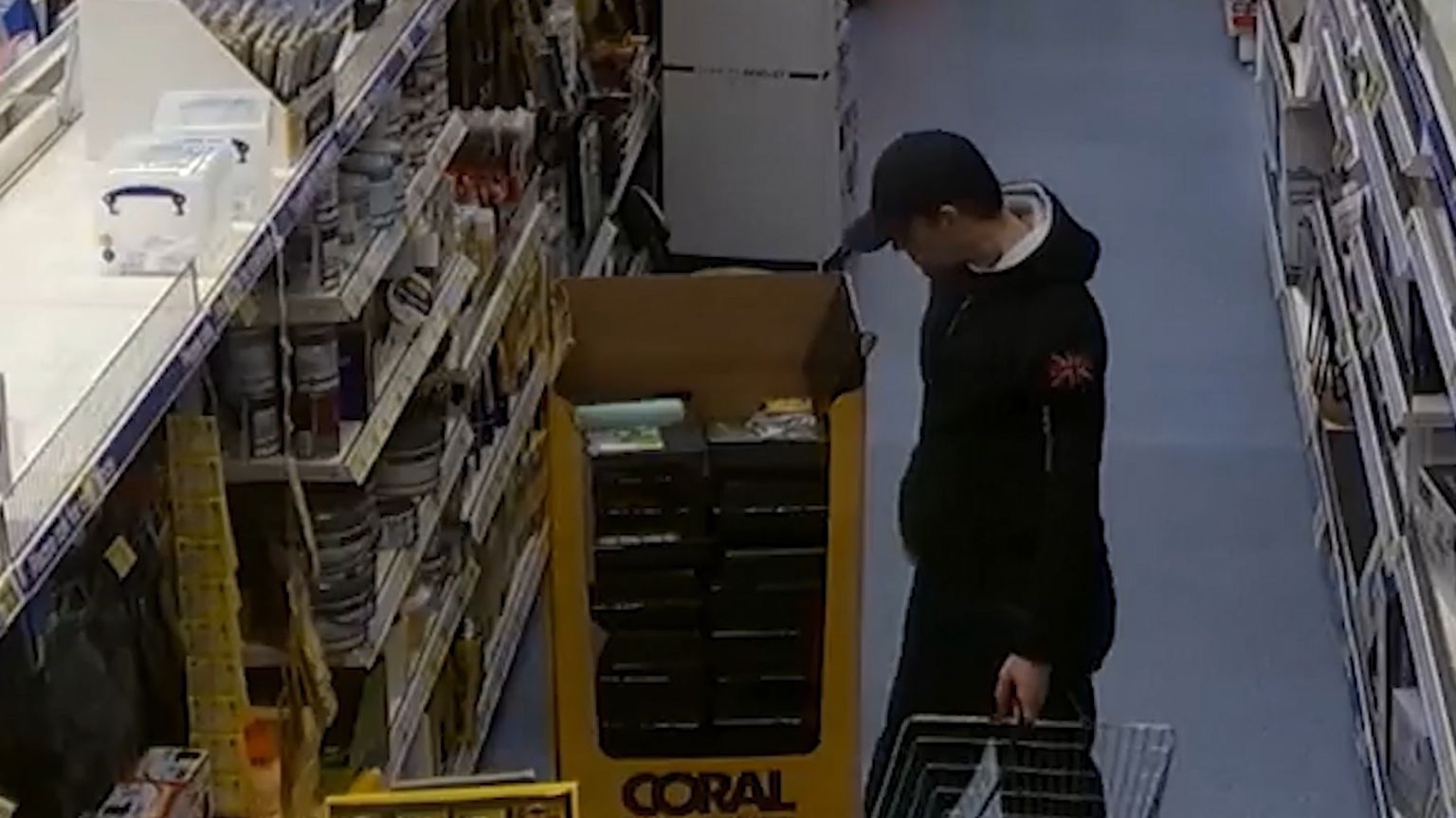 Robert Brown in a cap buying duct tape