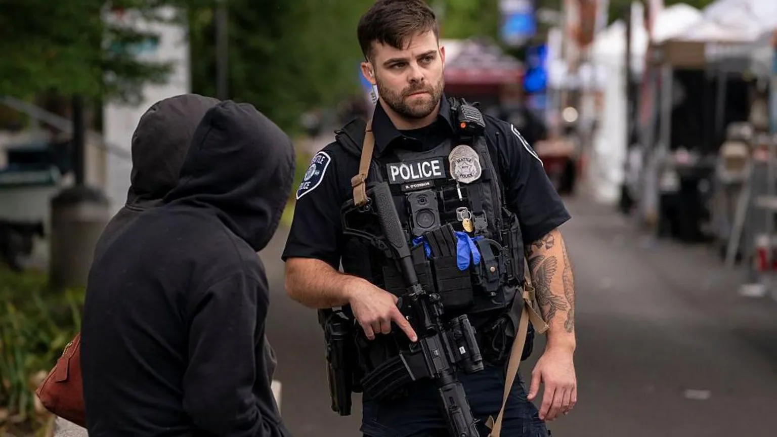 A police officer watches the scene after a mass shooting at the Bite of Seattle food festival