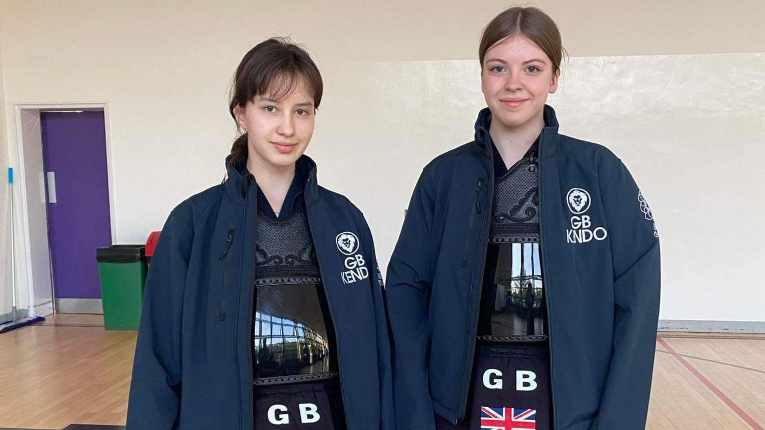 Keira (left) and Chloe pictured smiling while wearing their Team GB Kendo uniform