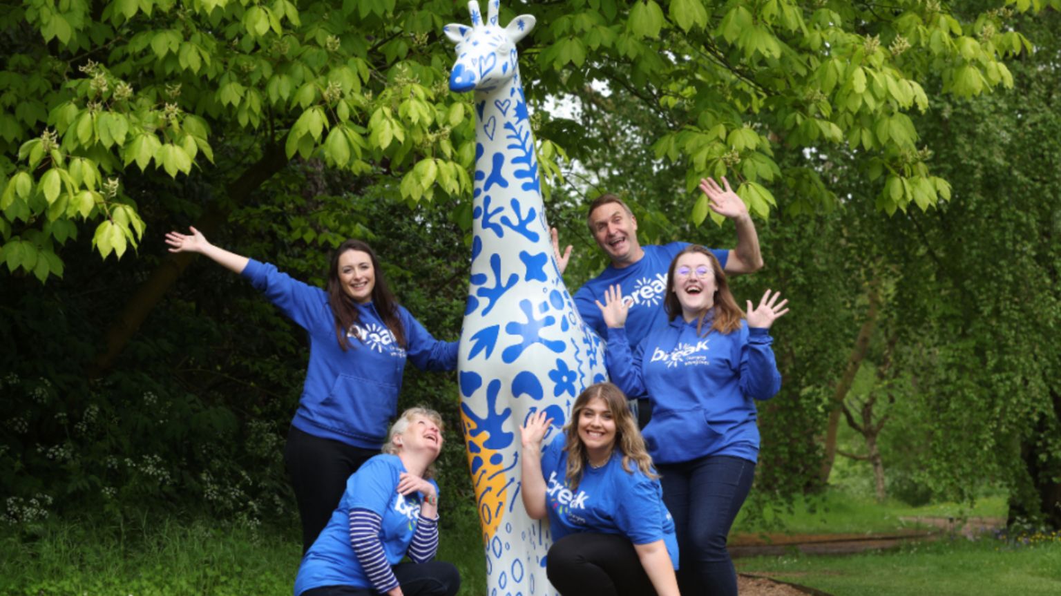 A group of Break supporters and one of the giraffes