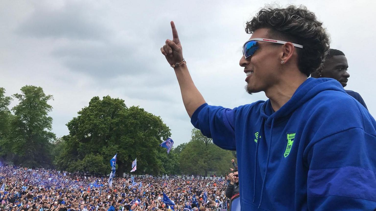 Jeremy Sarmiento holds a finger up to a crowd of Ipswich Town FC fans