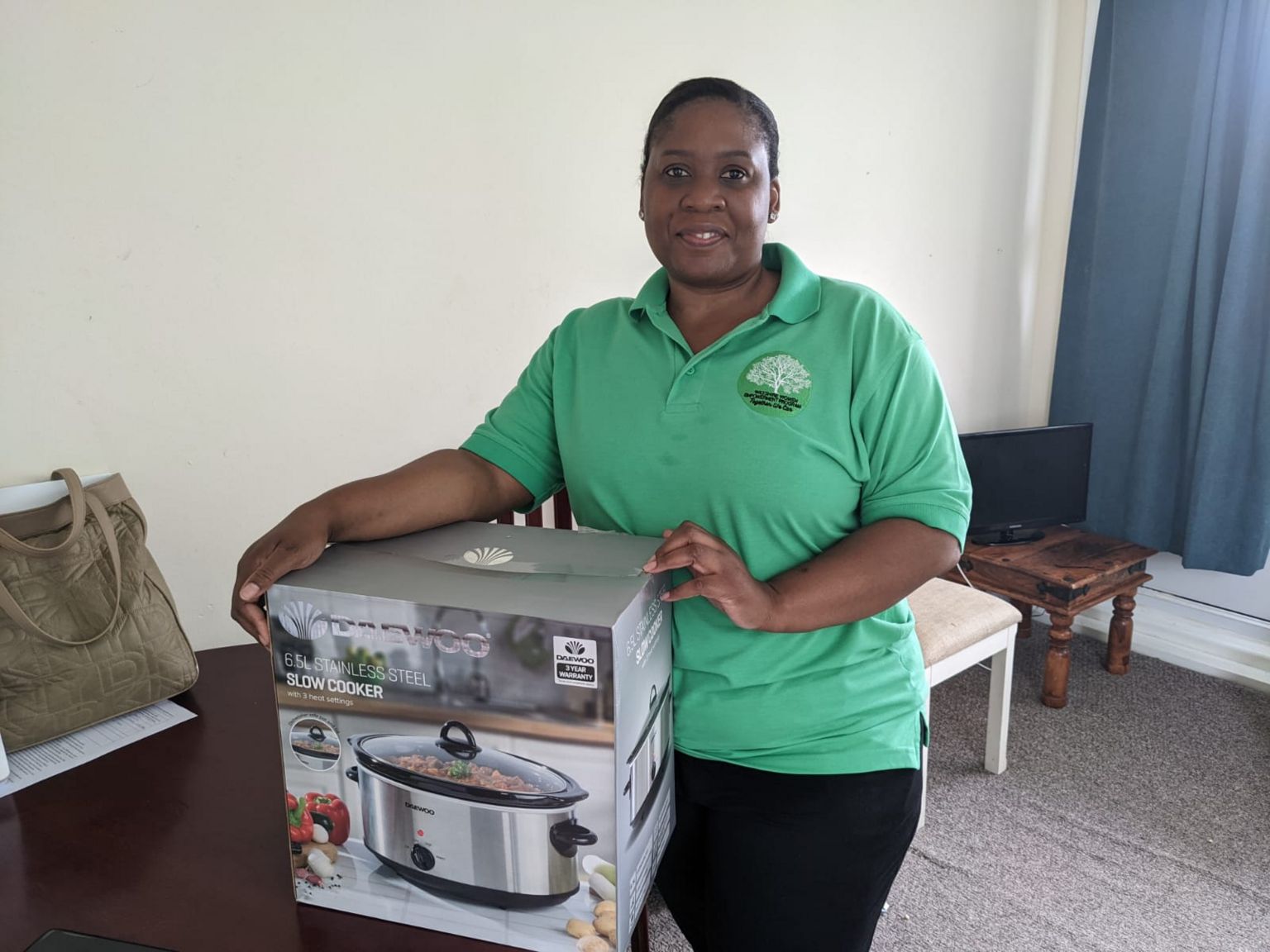 Thula Ndebele holding slow cookers in boxes