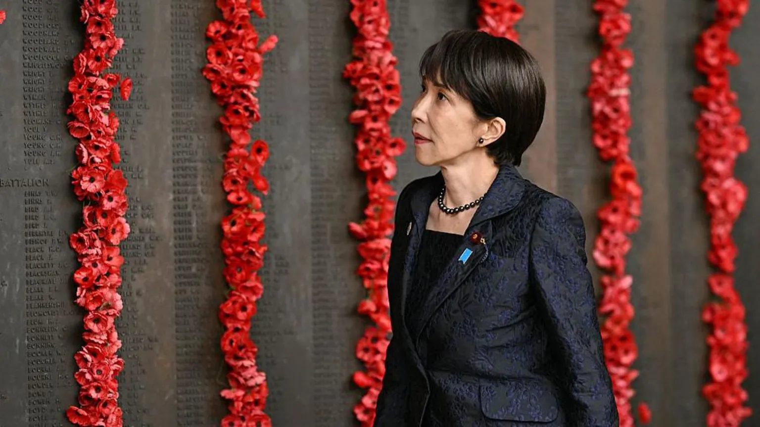 Getty Images Prime Minister Sanae Takaichi walks past poppies on the Roll of Honour during her visit to the Australian War Memorial in Canberra on May 4, 2026.