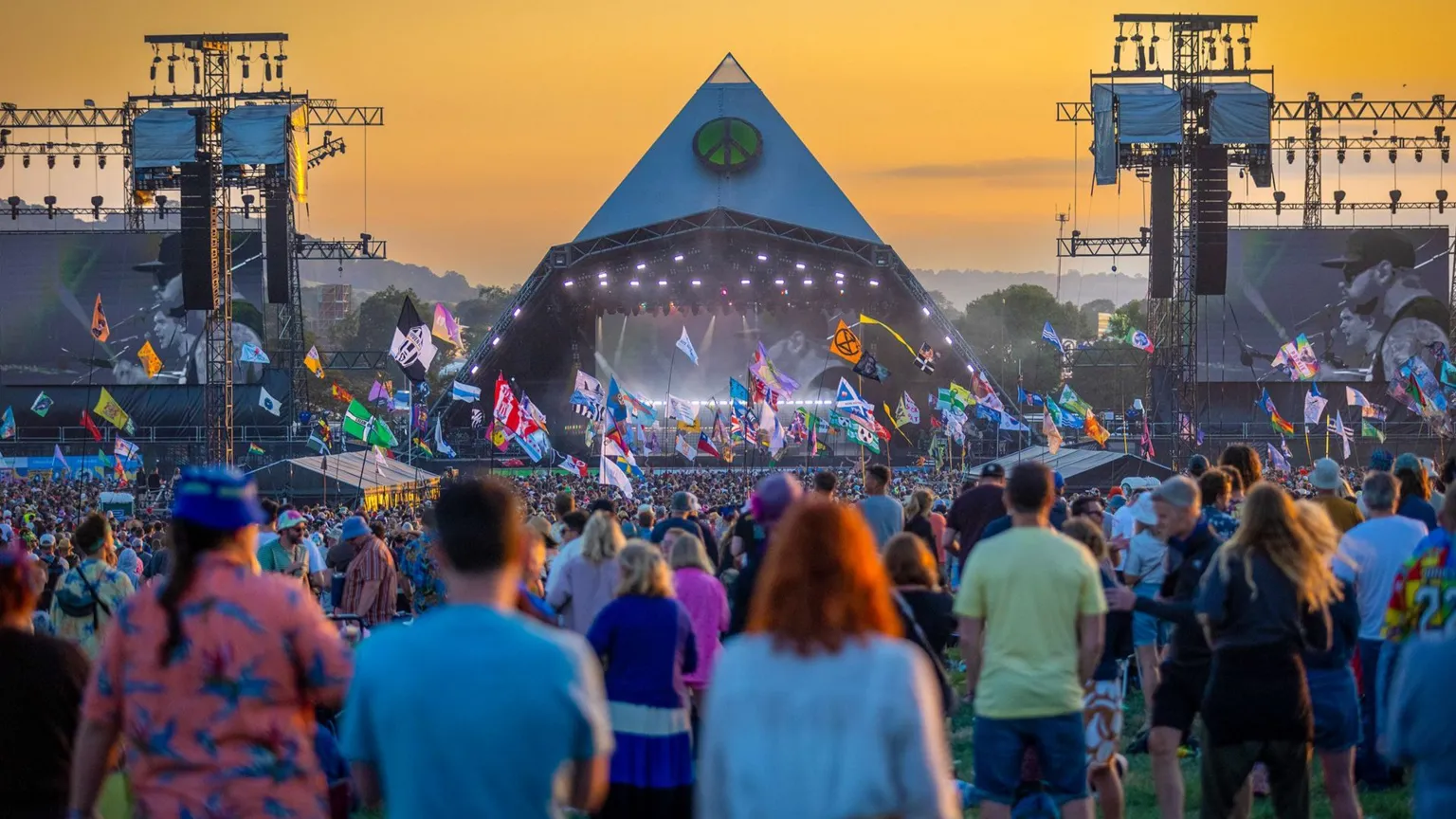 Getty Images People gather to watch an act on the main Pyramid Stage as the sun sets on Day 3 of the Glastonbury Festival 2023 held at Worthy Farm, Pilton in Glastonbury, England.