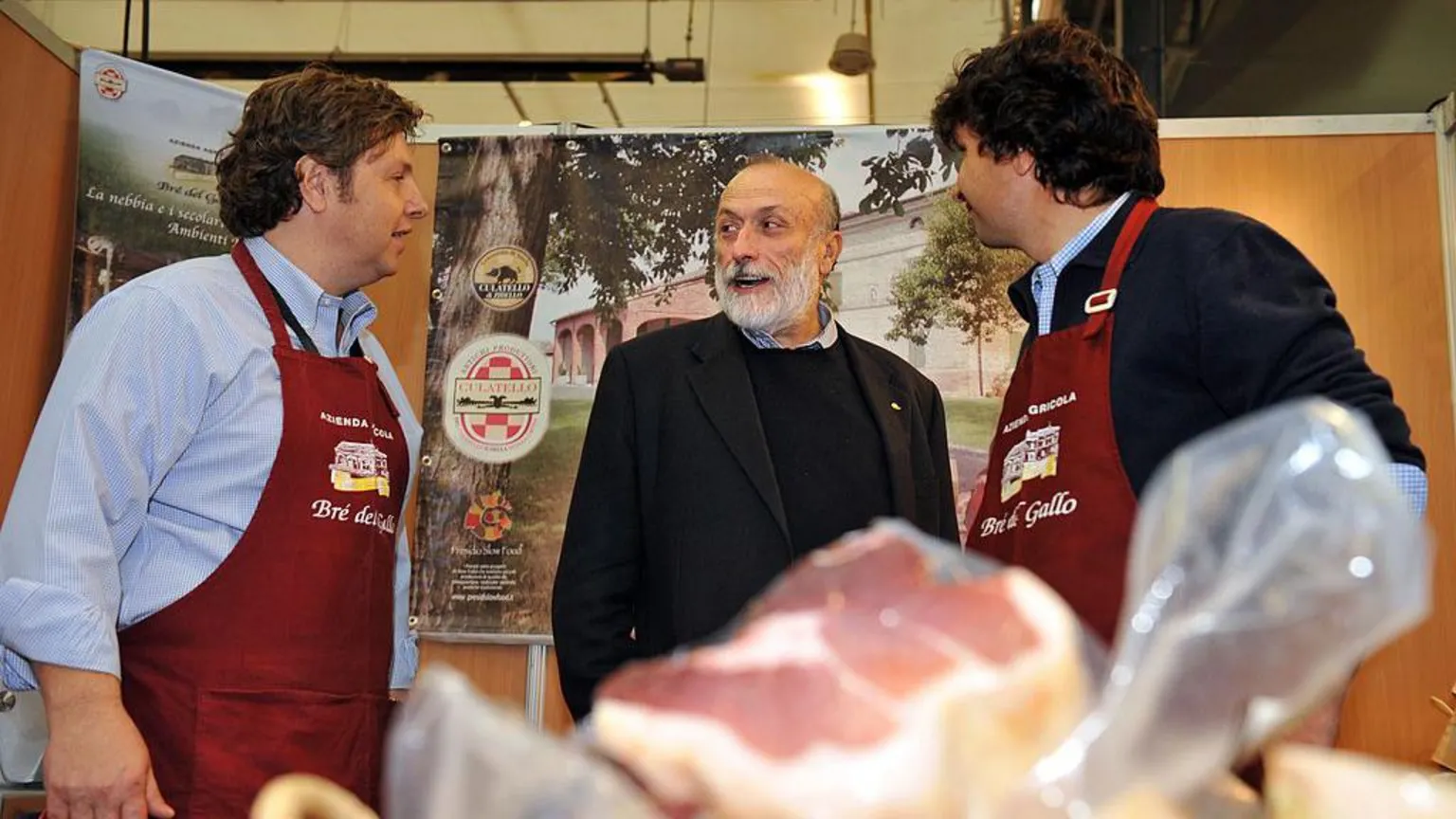Petrini speaks with Italian ham producers during a food festival in Tours in 2011