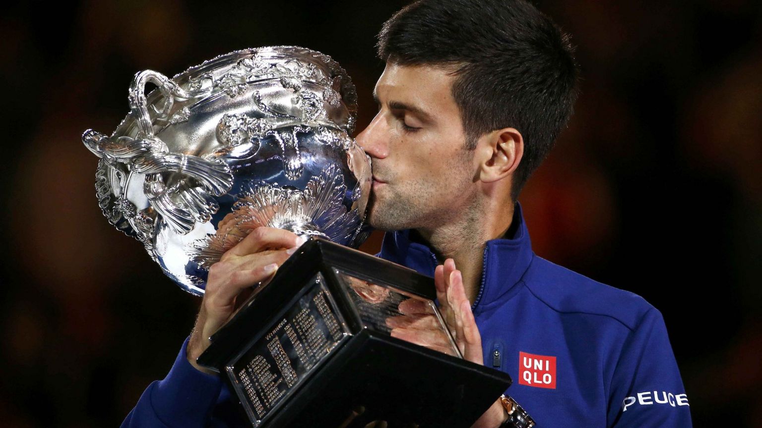 Novak Djokovic kisses the Norman Brookes trophy