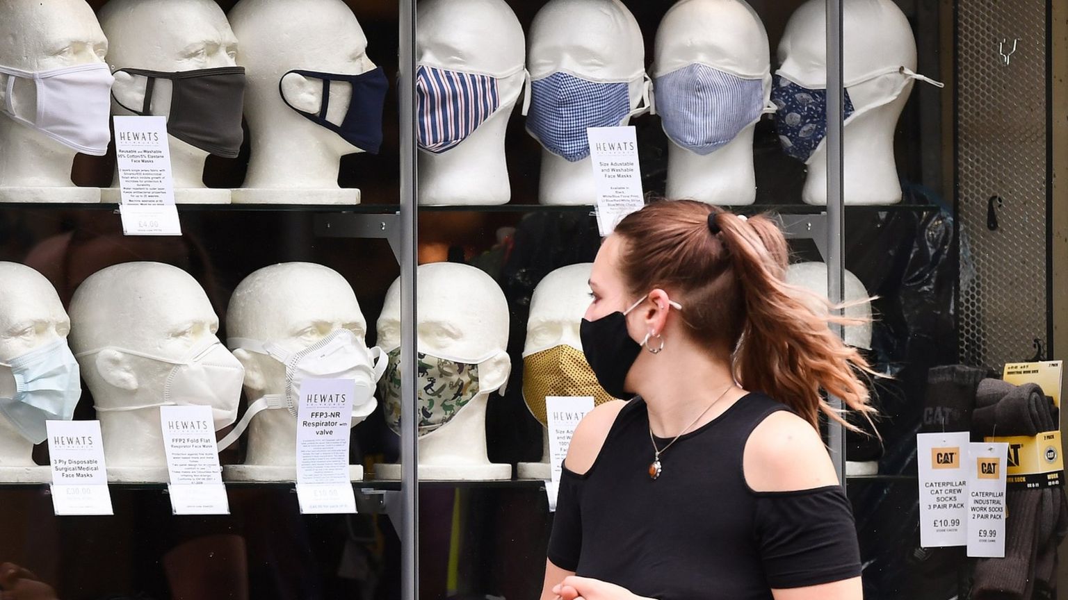 Woman looking at masks in shop