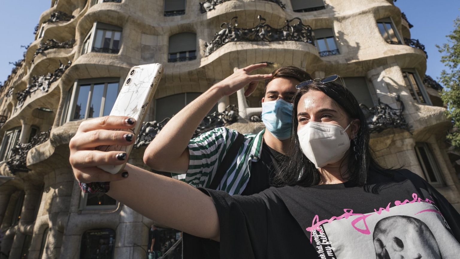 People pose for selfies in Barcelona, Spain, 27 July 2020