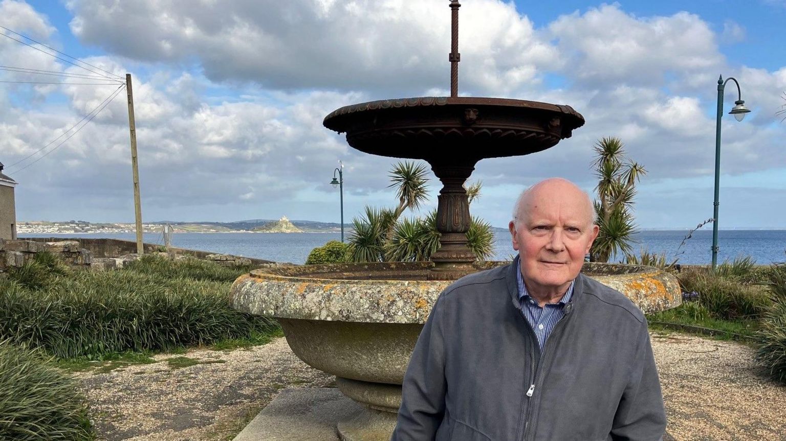 Man in front of fountain 