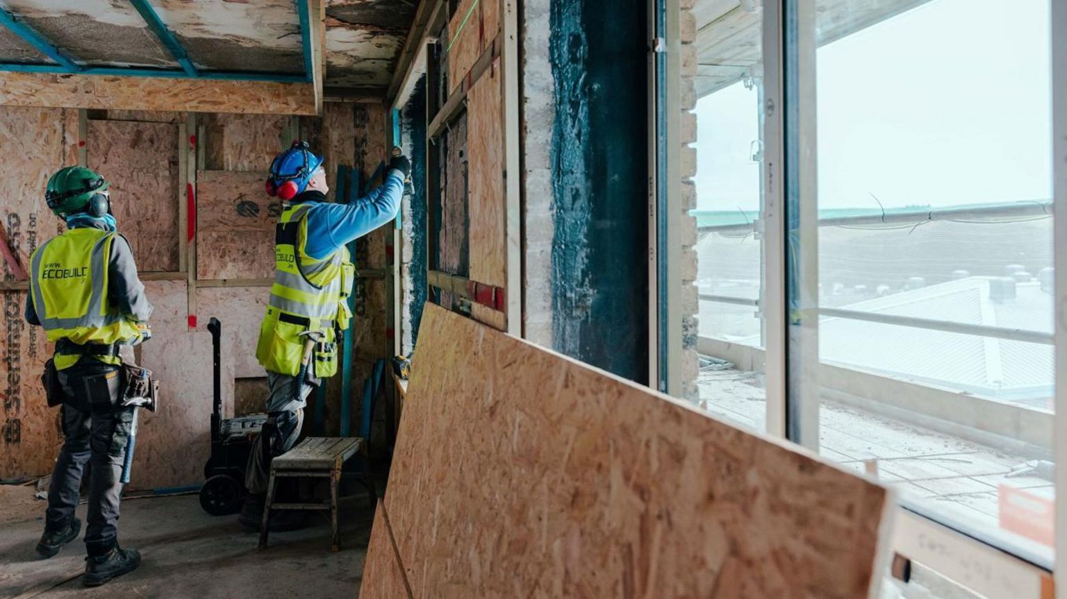 Workmen putting working on timber on the inside of the development