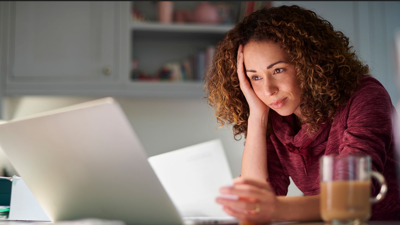 A woman looking frustrated by a computer